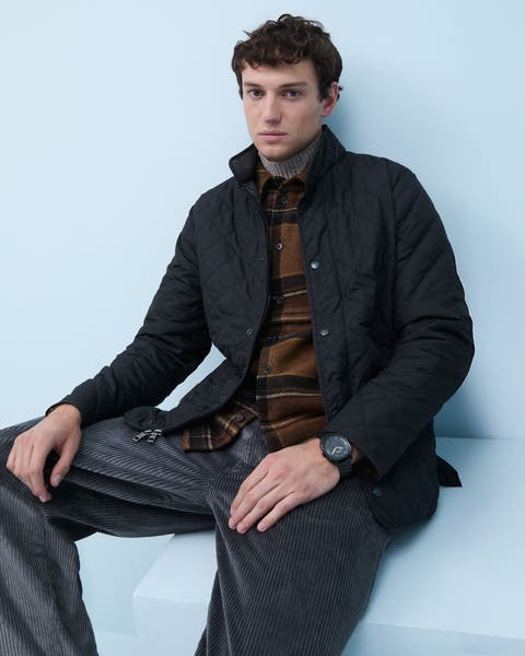 A man wearing a quilted jacket.