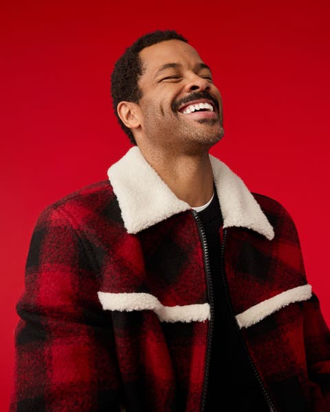 A man wearing a plaid jacket.