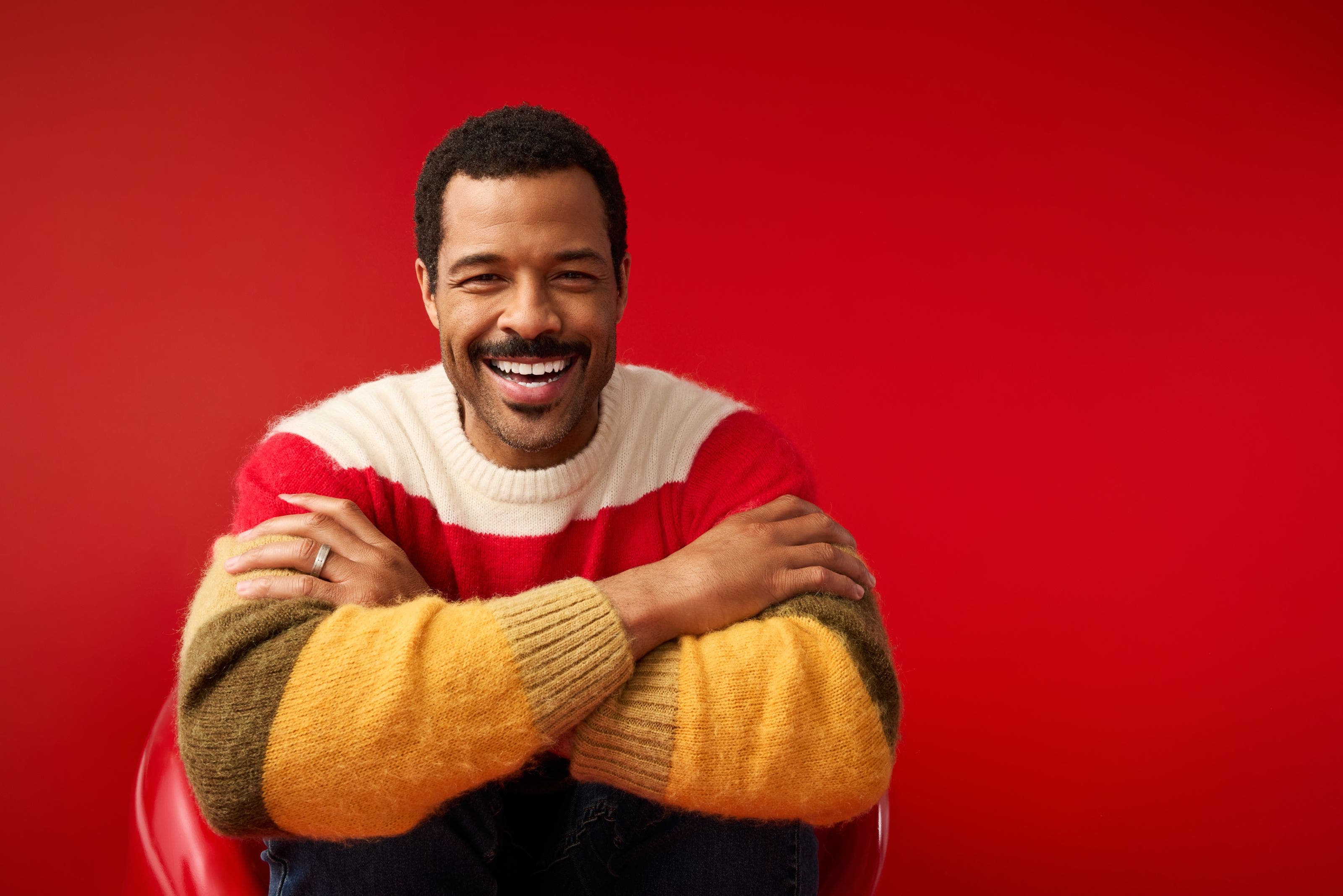 A man wearing a striped sweater. 