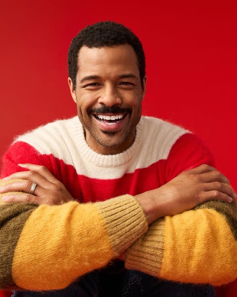 A man wearing a striped sweater.