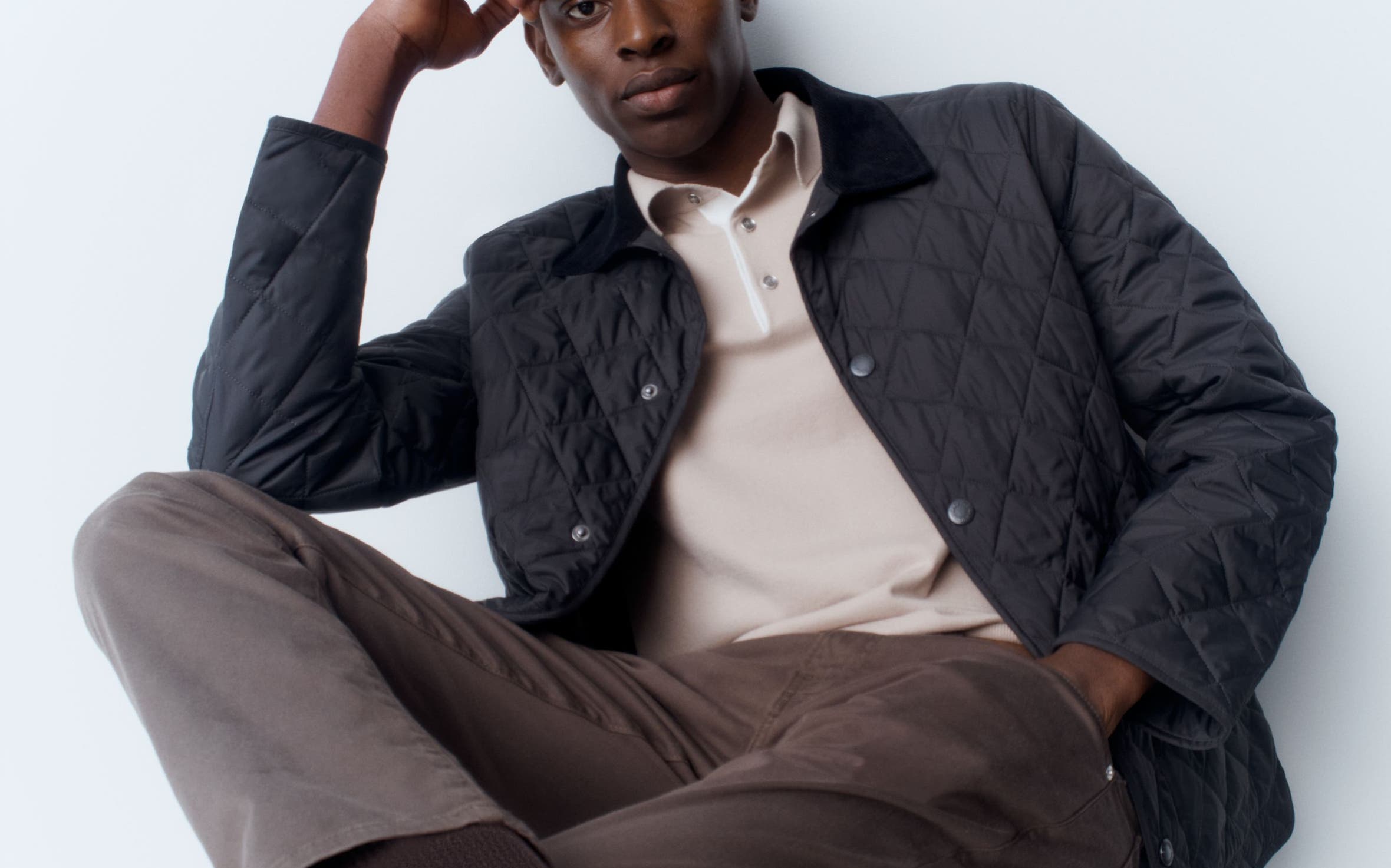 A man wearing a Barbour jacket with a Reiss polo, FRAME twill pants, BOSS belt and Bruno Magli shoes.