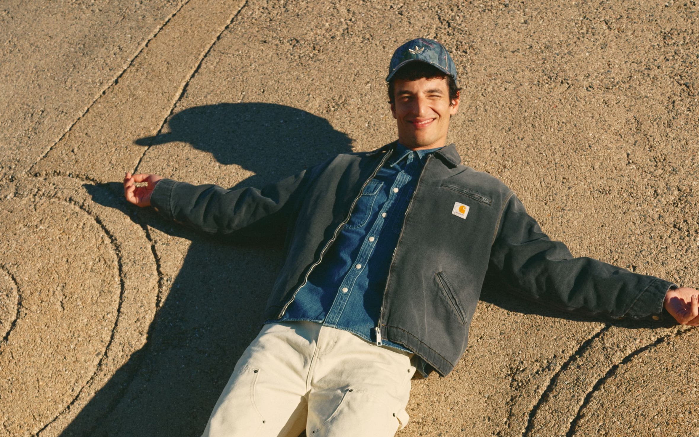 Man wearing a workwear jacket, denim shirt, carpenter jeans and boots.