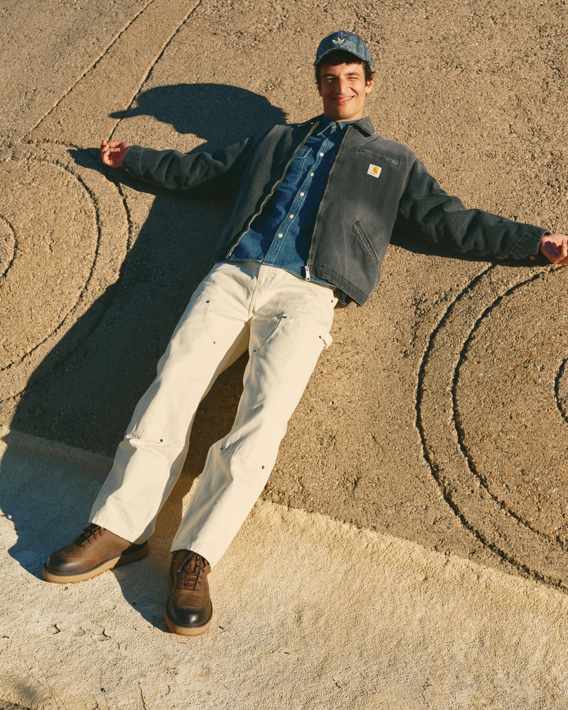 Man wearing a workwear jacket, denim shirt, carpenter jeans and boots.