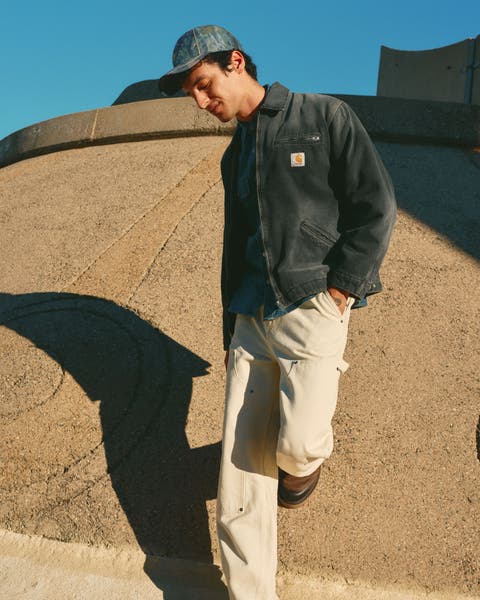 A man wearing a work jacket from Carhartt WIP.