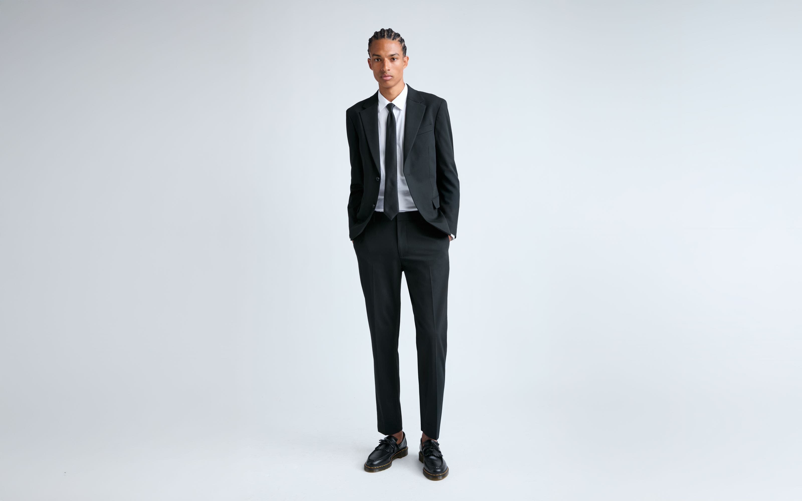 A man wearing a black suit.