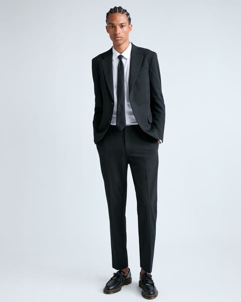 A man wearing a black suit.