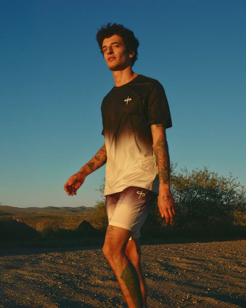 Man wearing an ombre active tee and shorts.