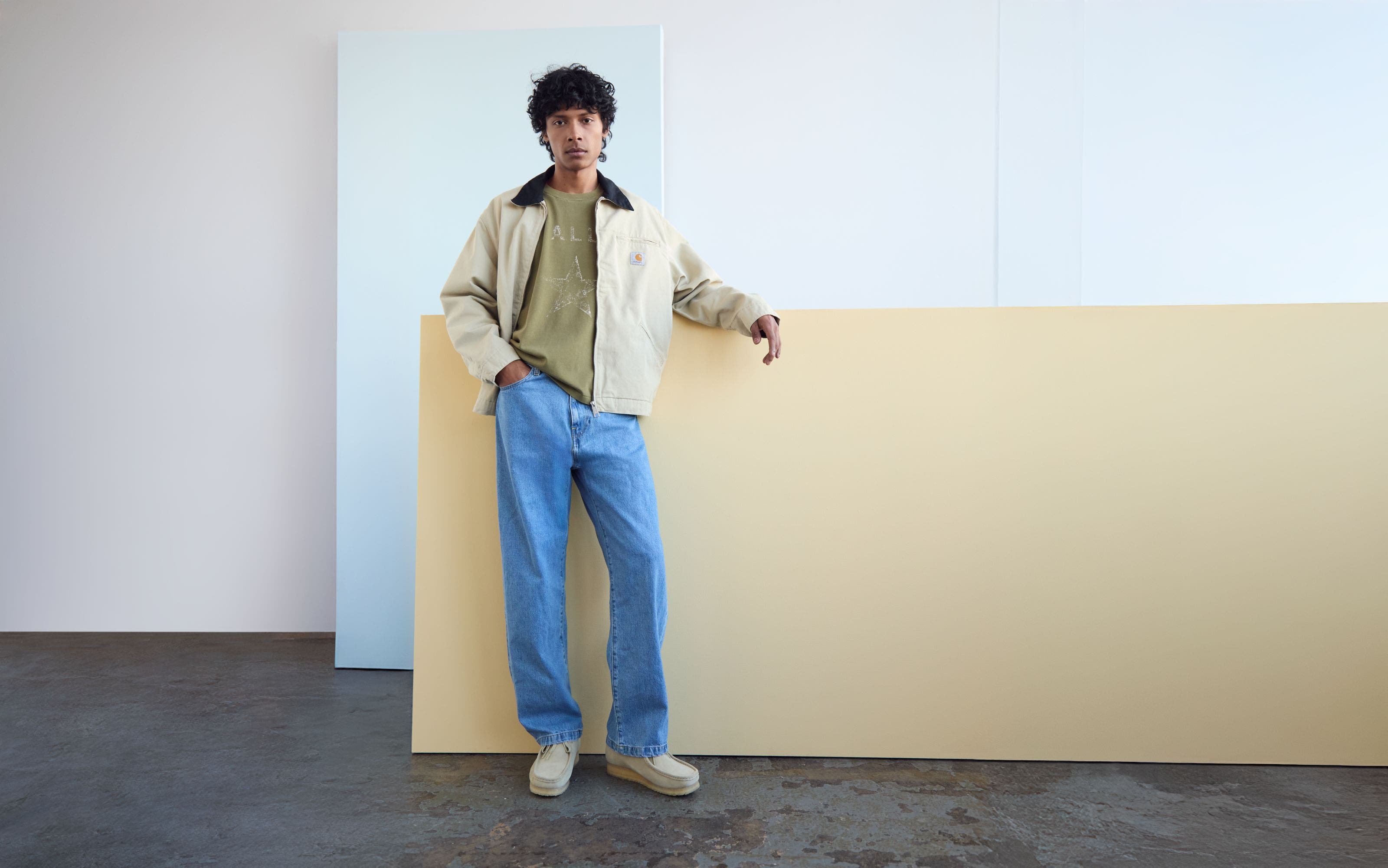 A man wearing a light tan utility jacket.