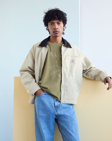 A man wearing a light tan utility jacket.