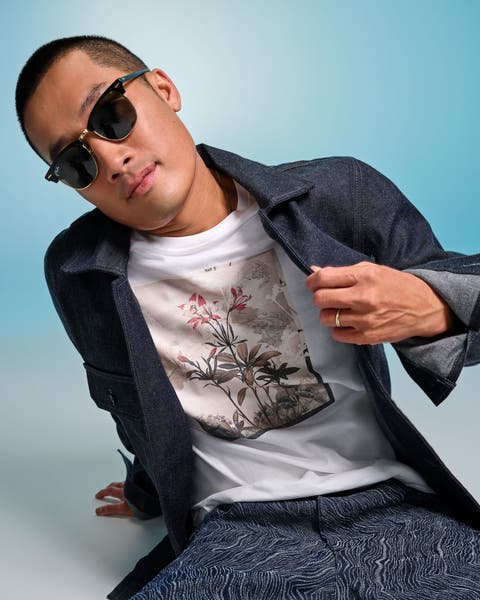Man in t-shirt layered with button down shirt.