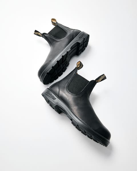 A pair of black leather Chelsea boots.