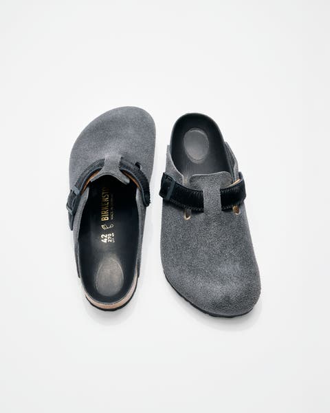 A pair of grey birkenstock slip on clogs.