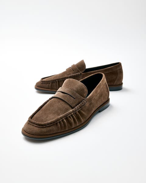 A pair of brown suede loafers.