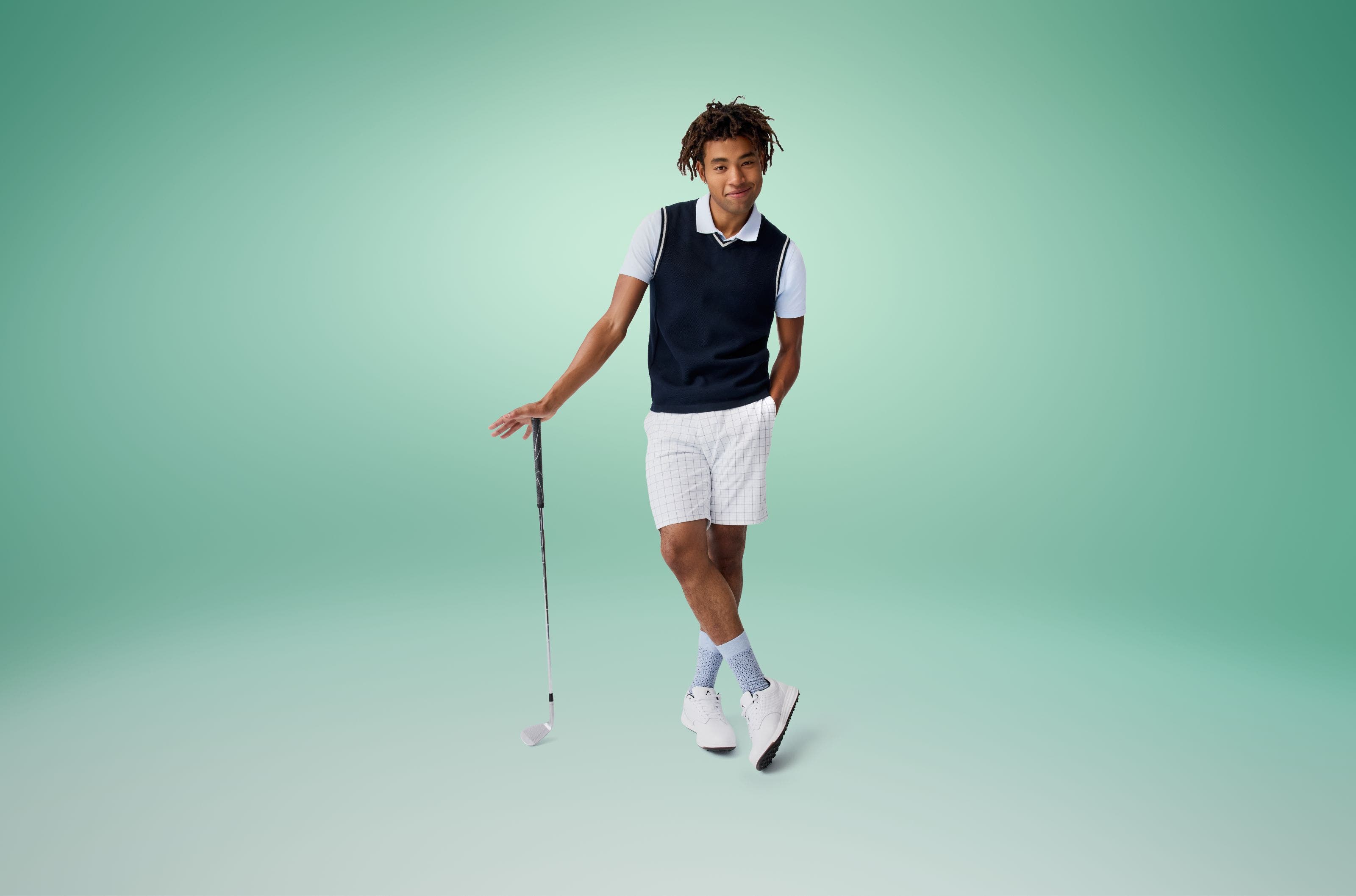 A man models a golf outfit. 