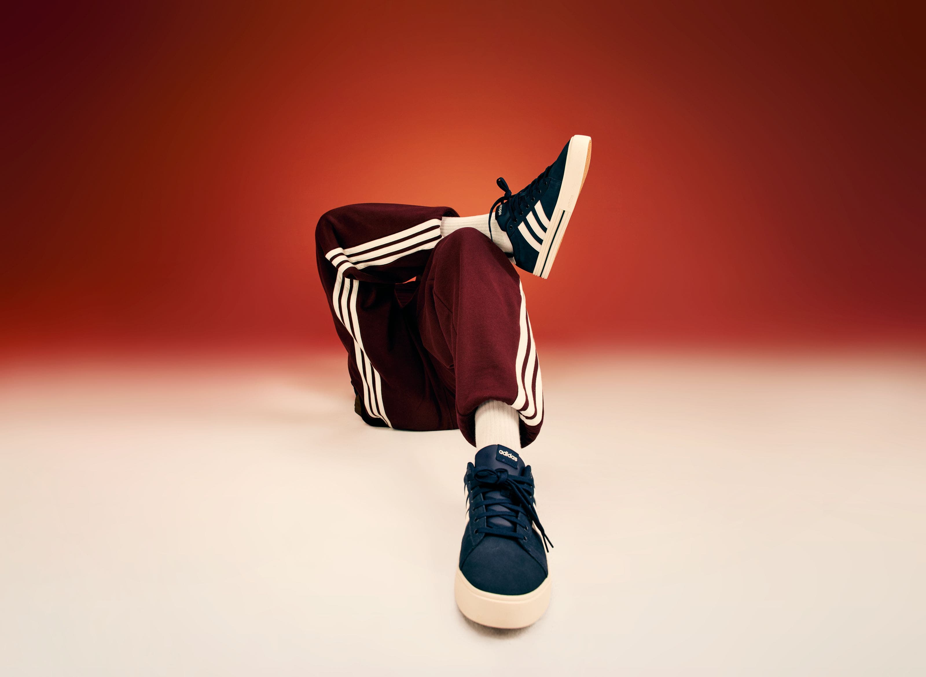 A closeup image of a person wearing blue sneakers. 