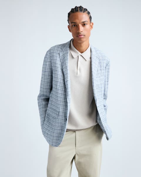 A man wearing a light-blue check sport coat.