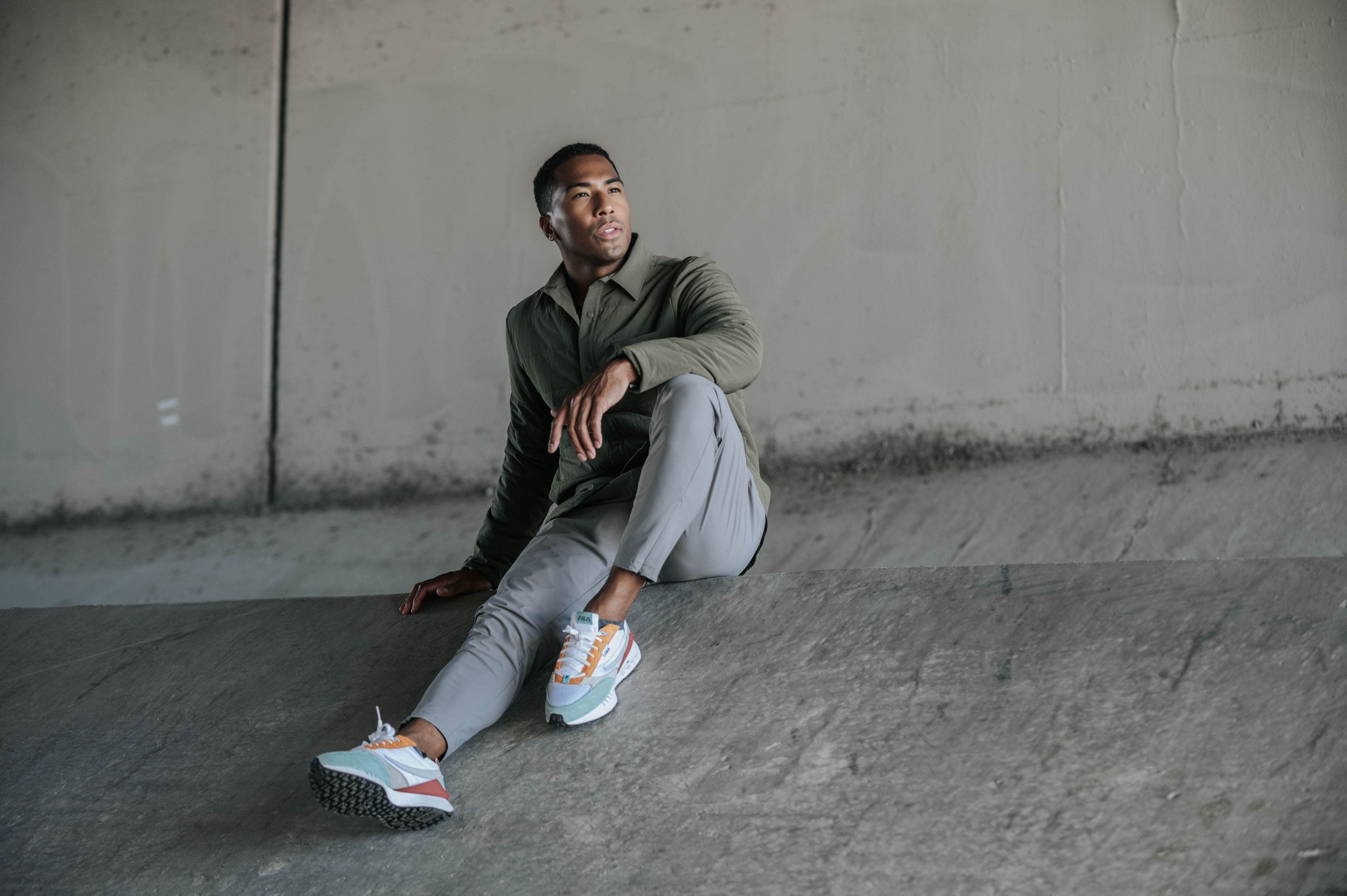 Man wearing olive Zella button up and grey pants.