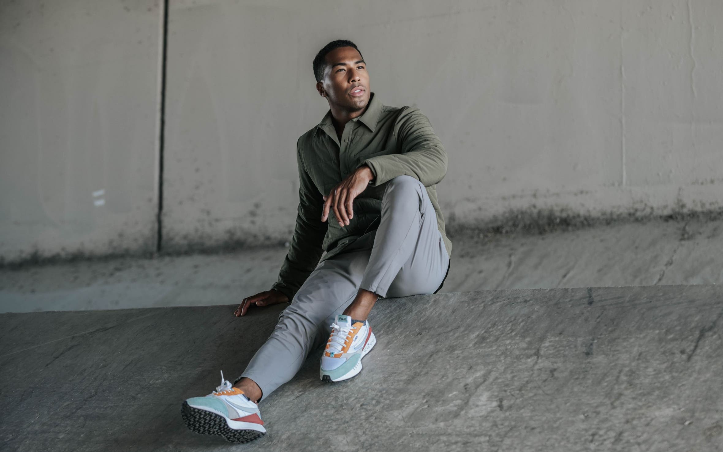 Man wearing olive Zella button up and grey pants.