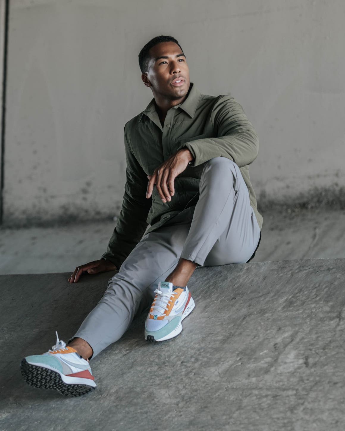 Man wearing olive Zella button up and grey pants.