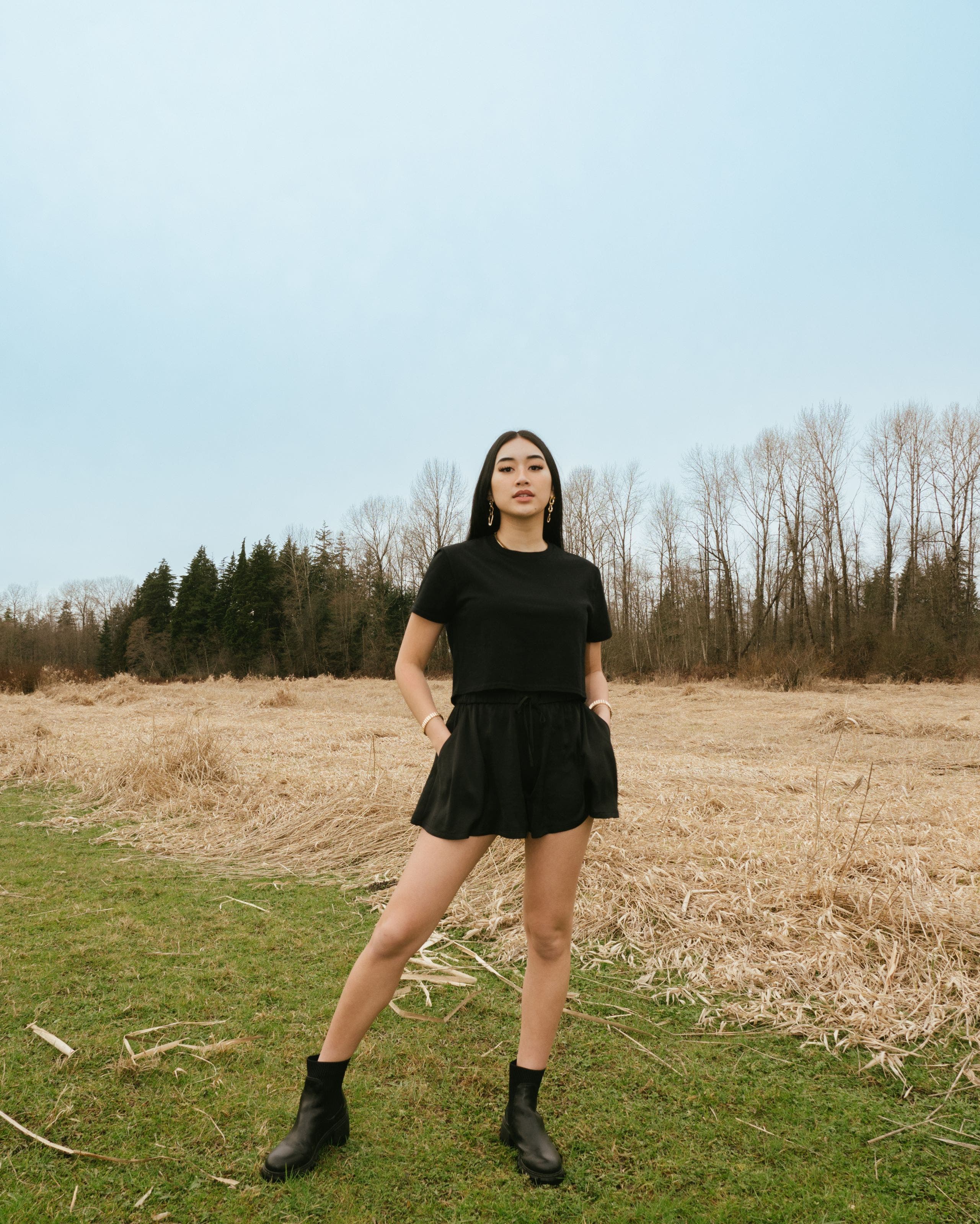 A woman in a matching black skort and T-shirt.