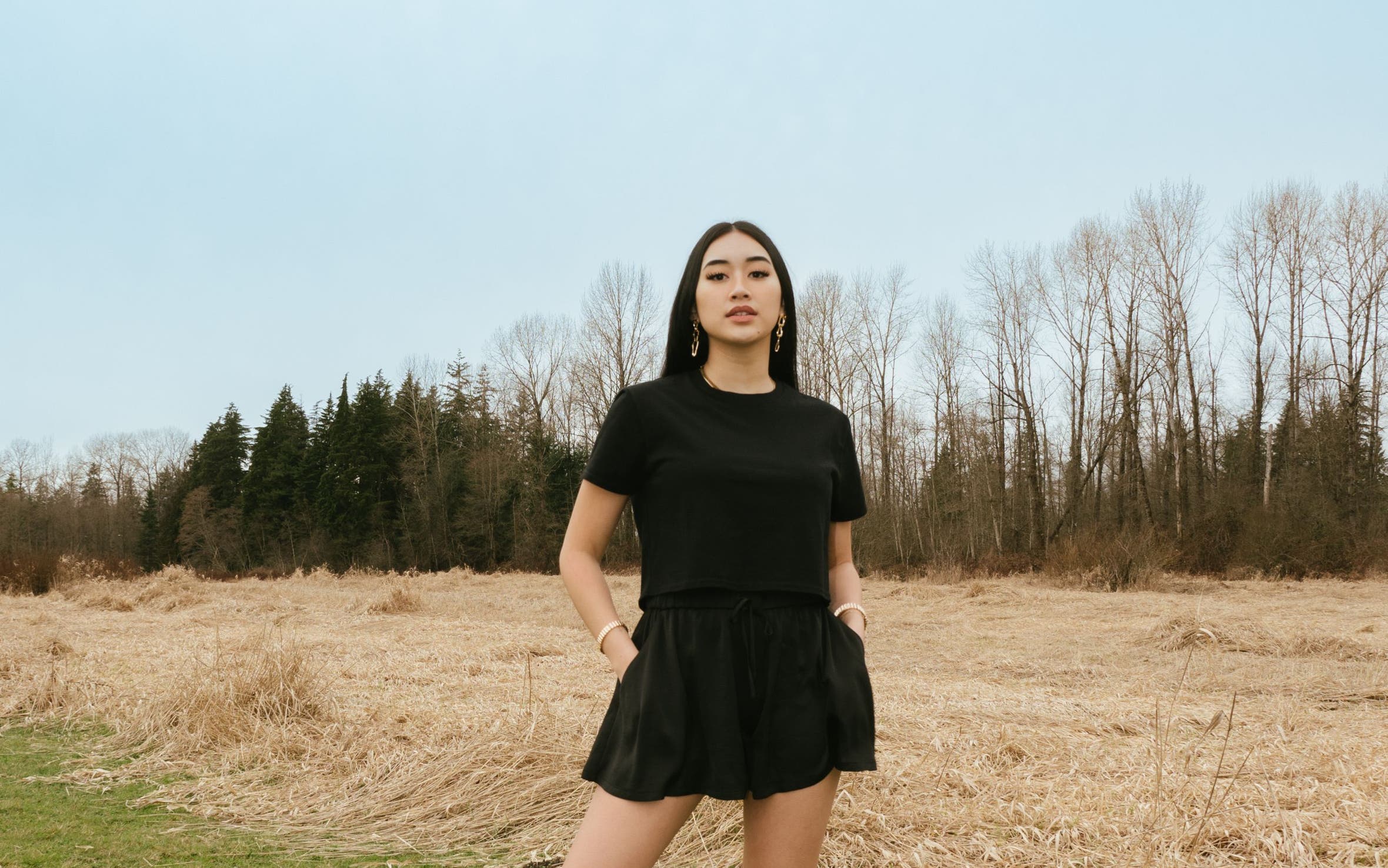 A woman in a matching black skort and T-shirt.