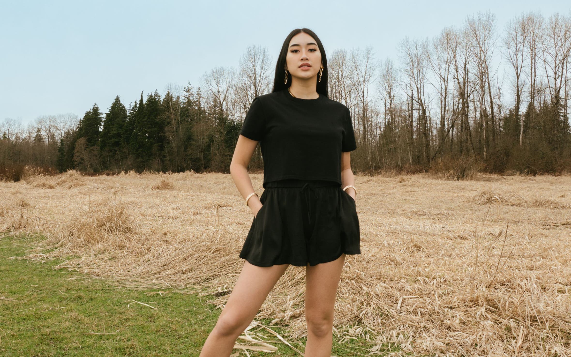 A woman in a matching black skort and T-shirt.