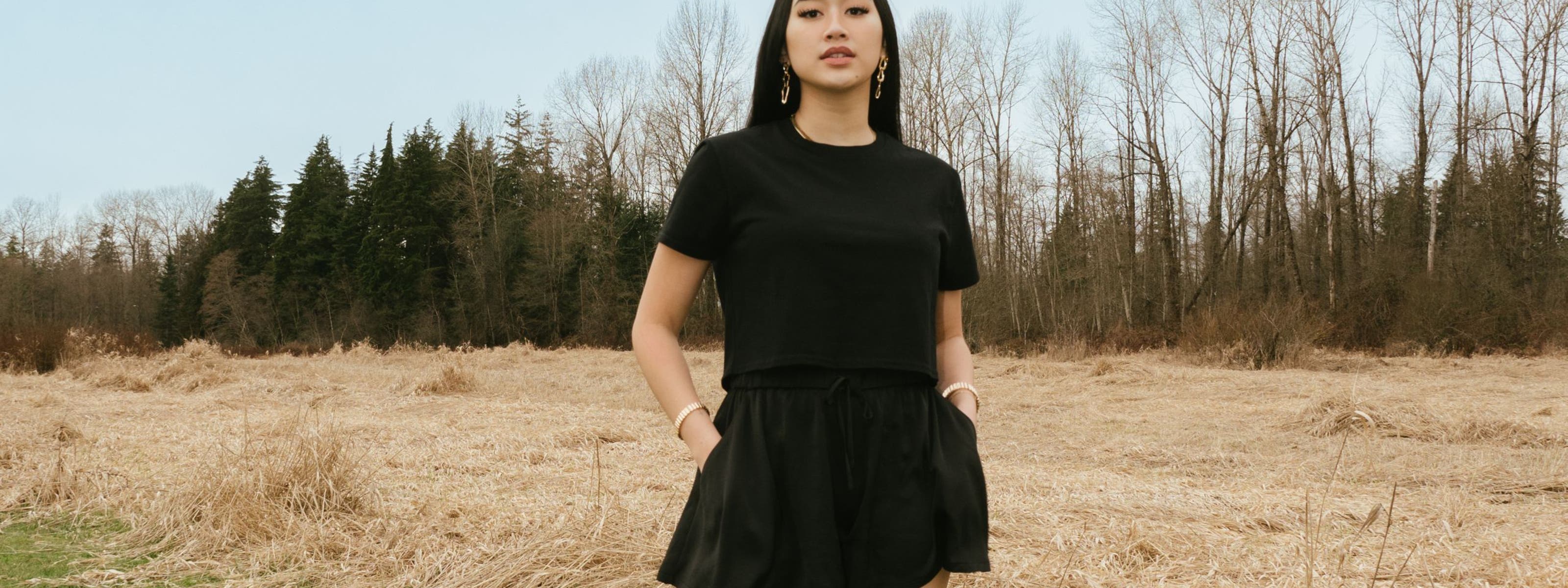 A woman in a matching black skort and T-shirt.