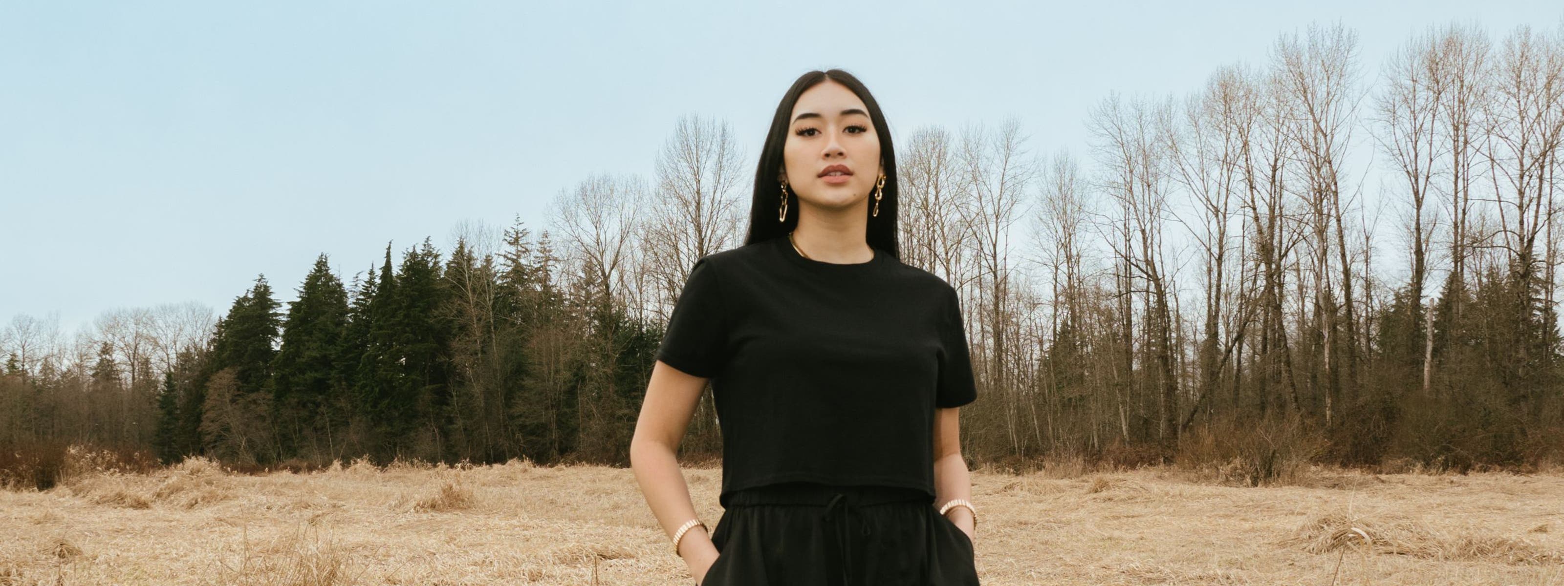 A woman in a matching black skort and T-shirt.