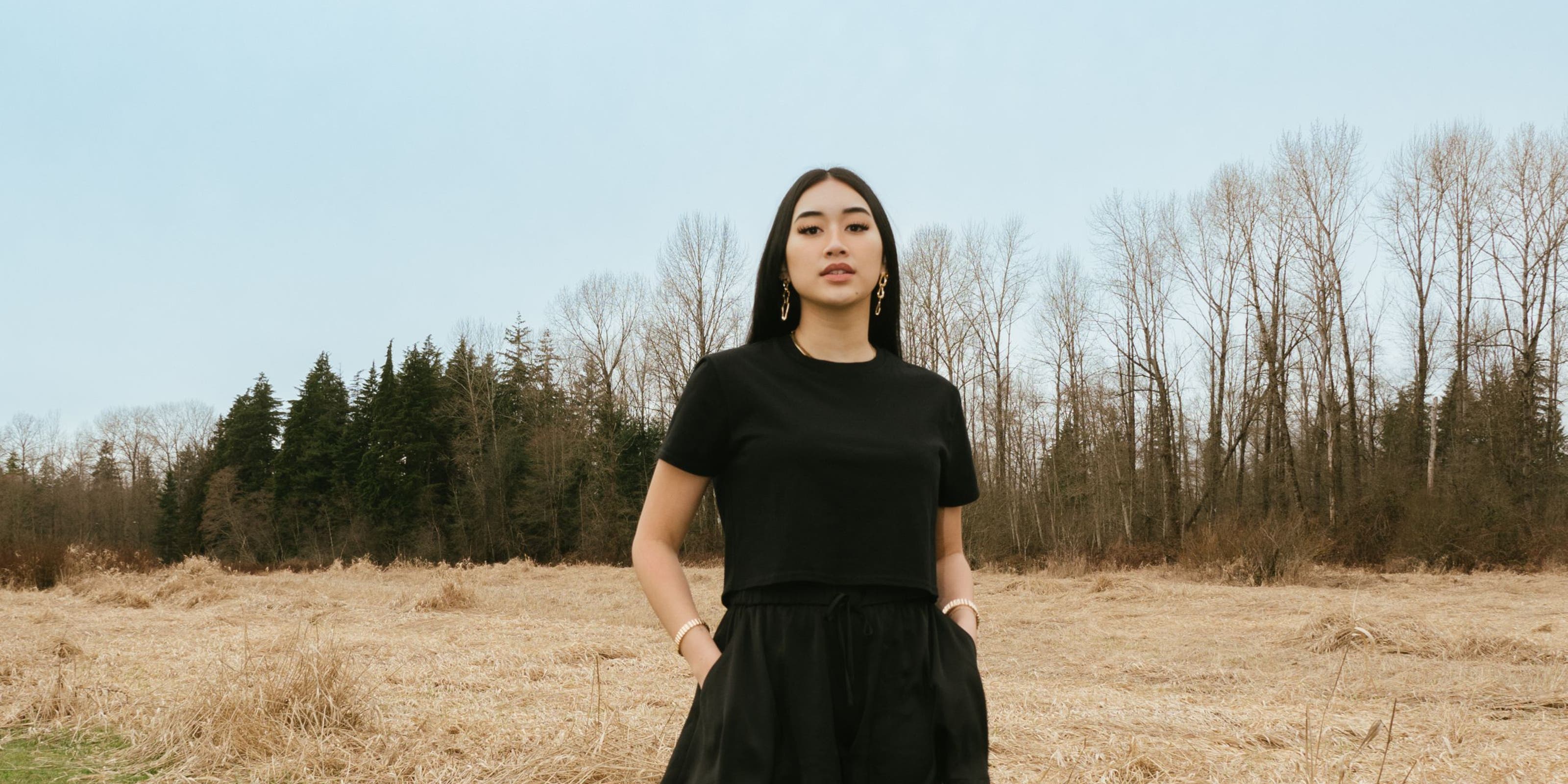 A woman in a matching black skort and T-shirt.