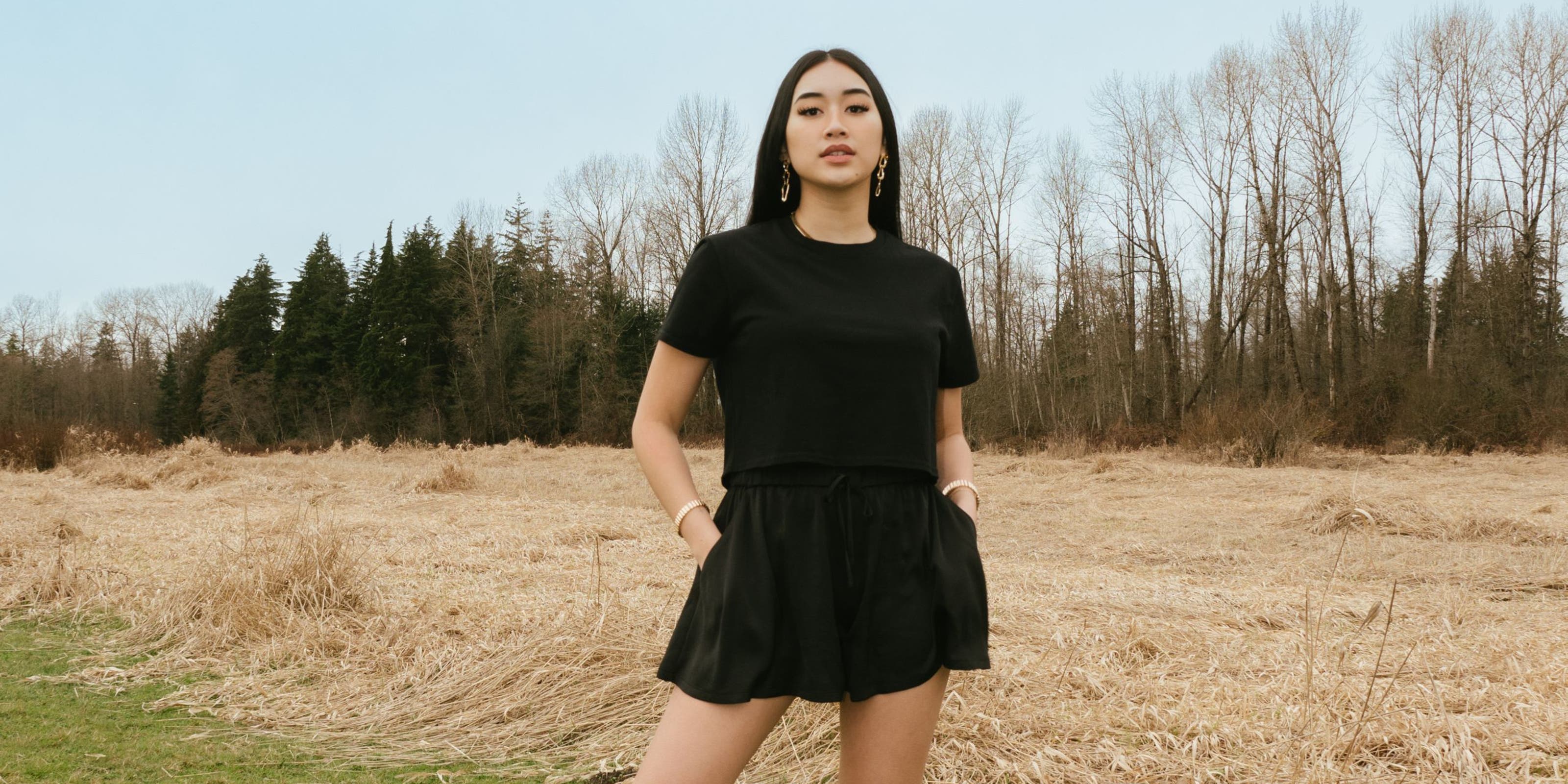 A woman in a matching black skort and T-shirt.