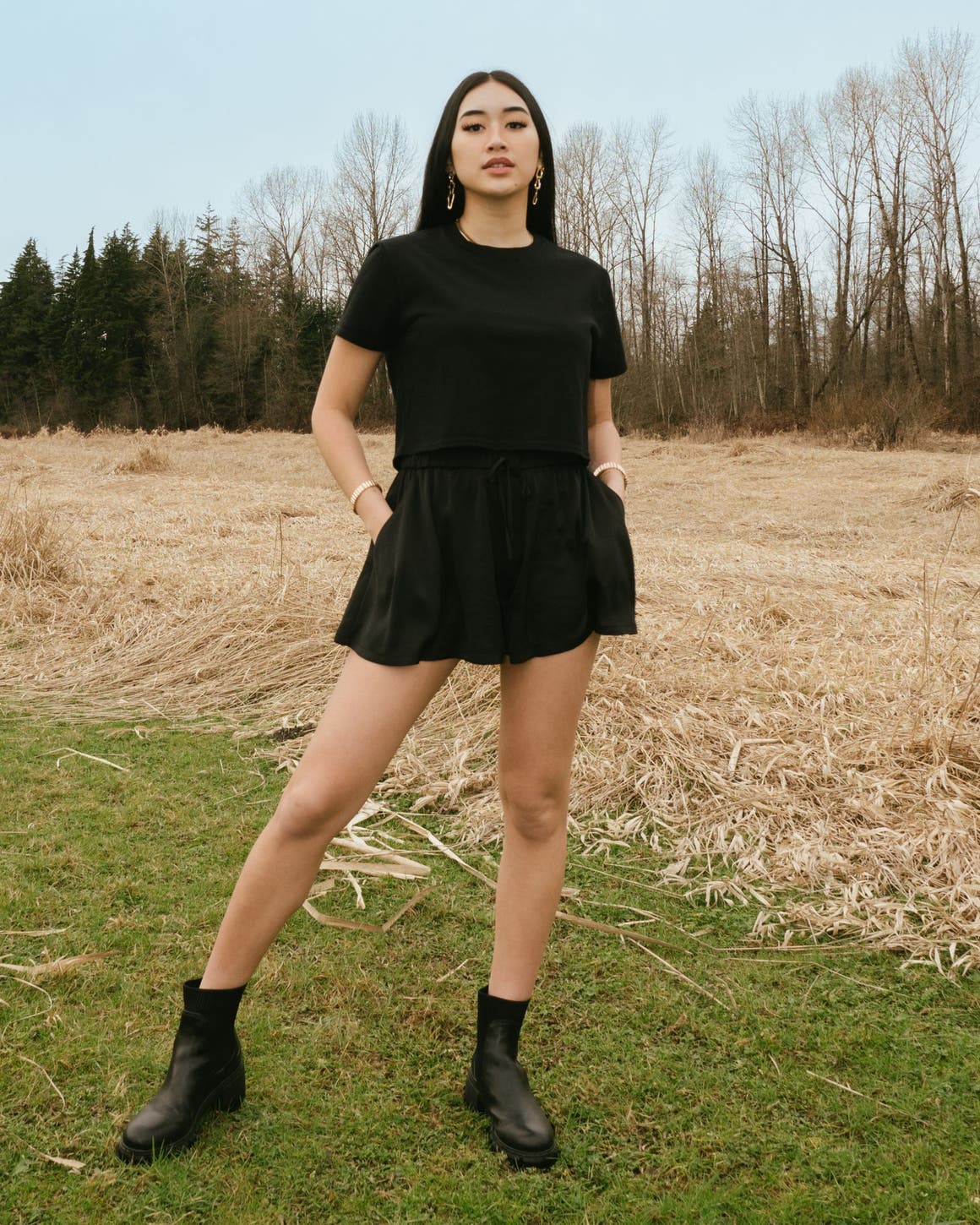 A woman in a matching black skort and T-shirt.