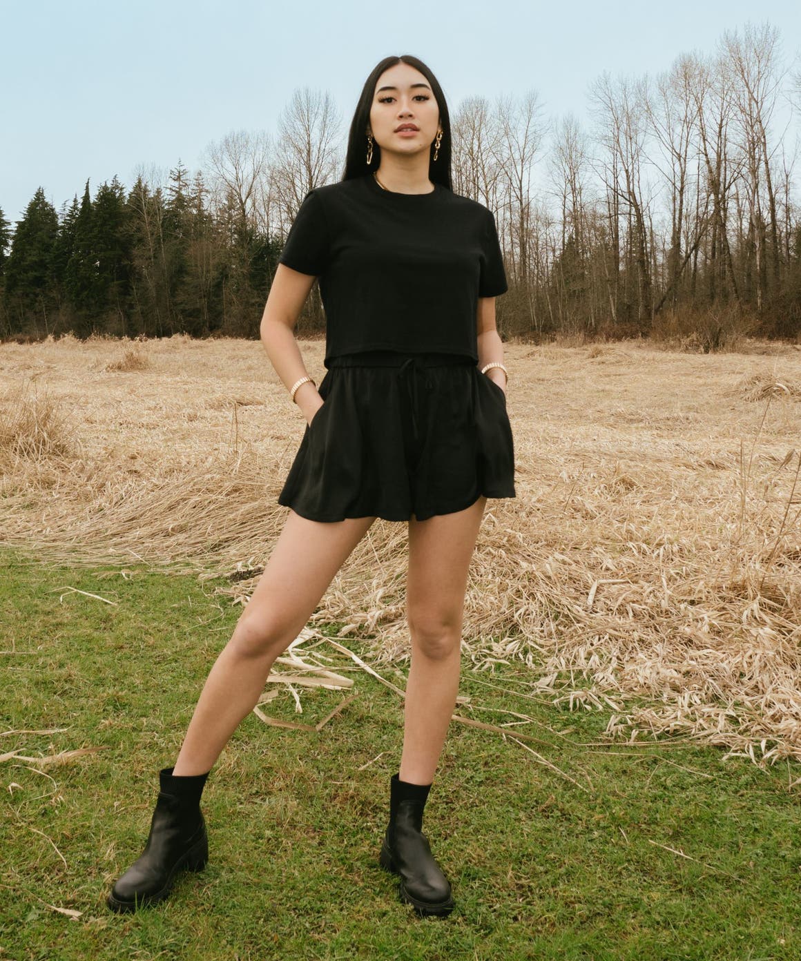 A woman in a matching black skort and T-shirt.