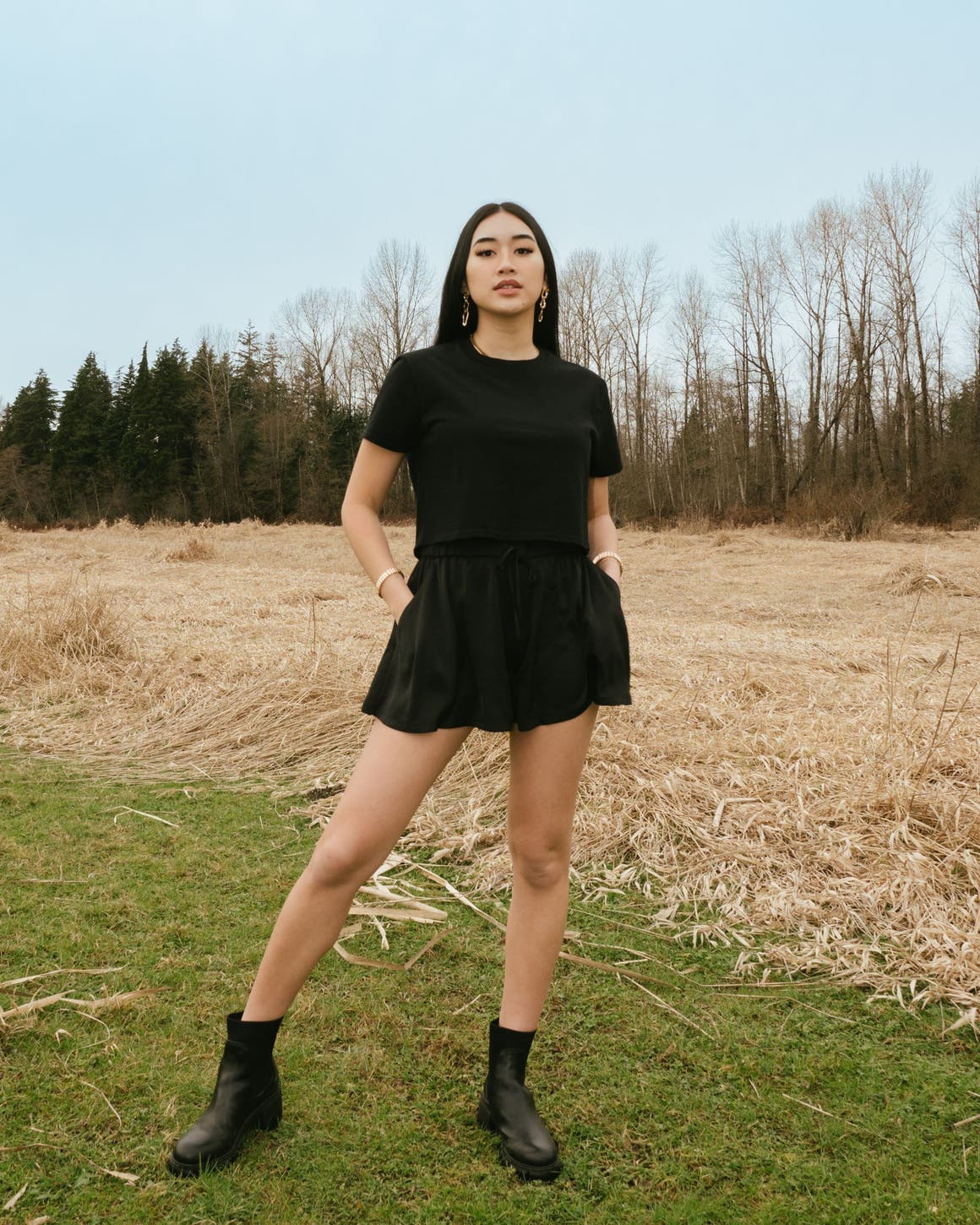 A woman in a matching black skort and T-shirt.