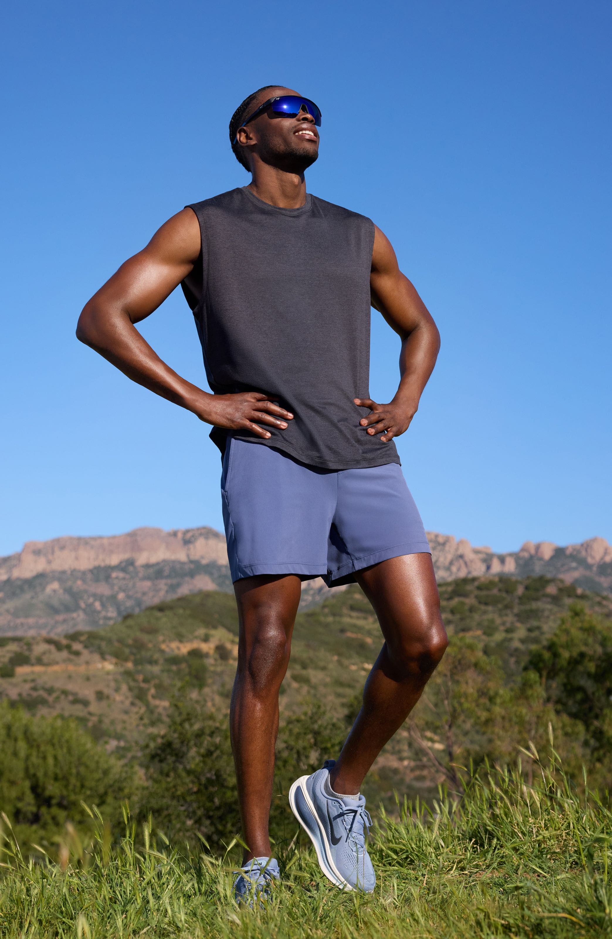 Man wearing a Zella tank top, shorts and running shoes.