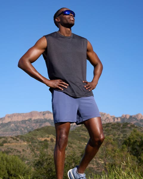 Man grey Zella tank top and blue shorts.