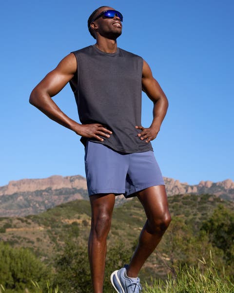 Man wearing a Zella tank top, shorts and running shoes.