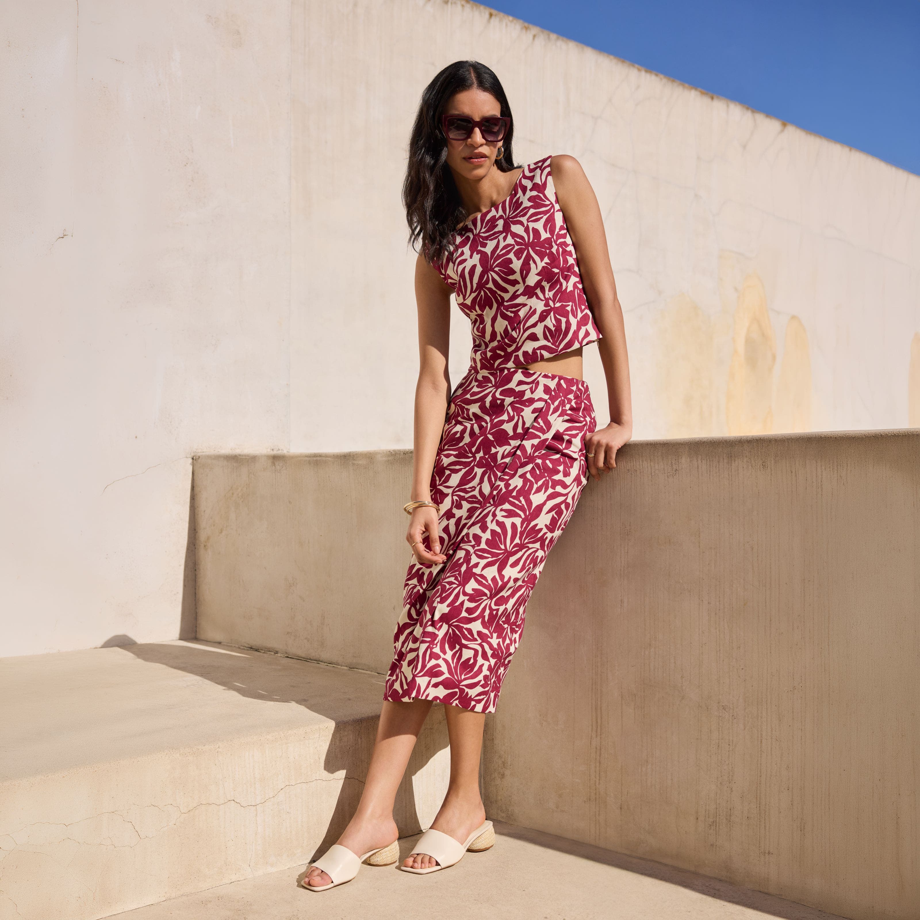 A woman wearing a sleeveless dress with sandals.