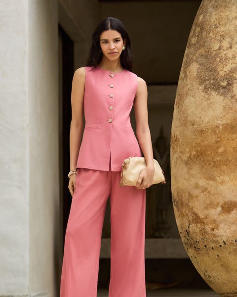 Woman wearing a pink tailored matching set.