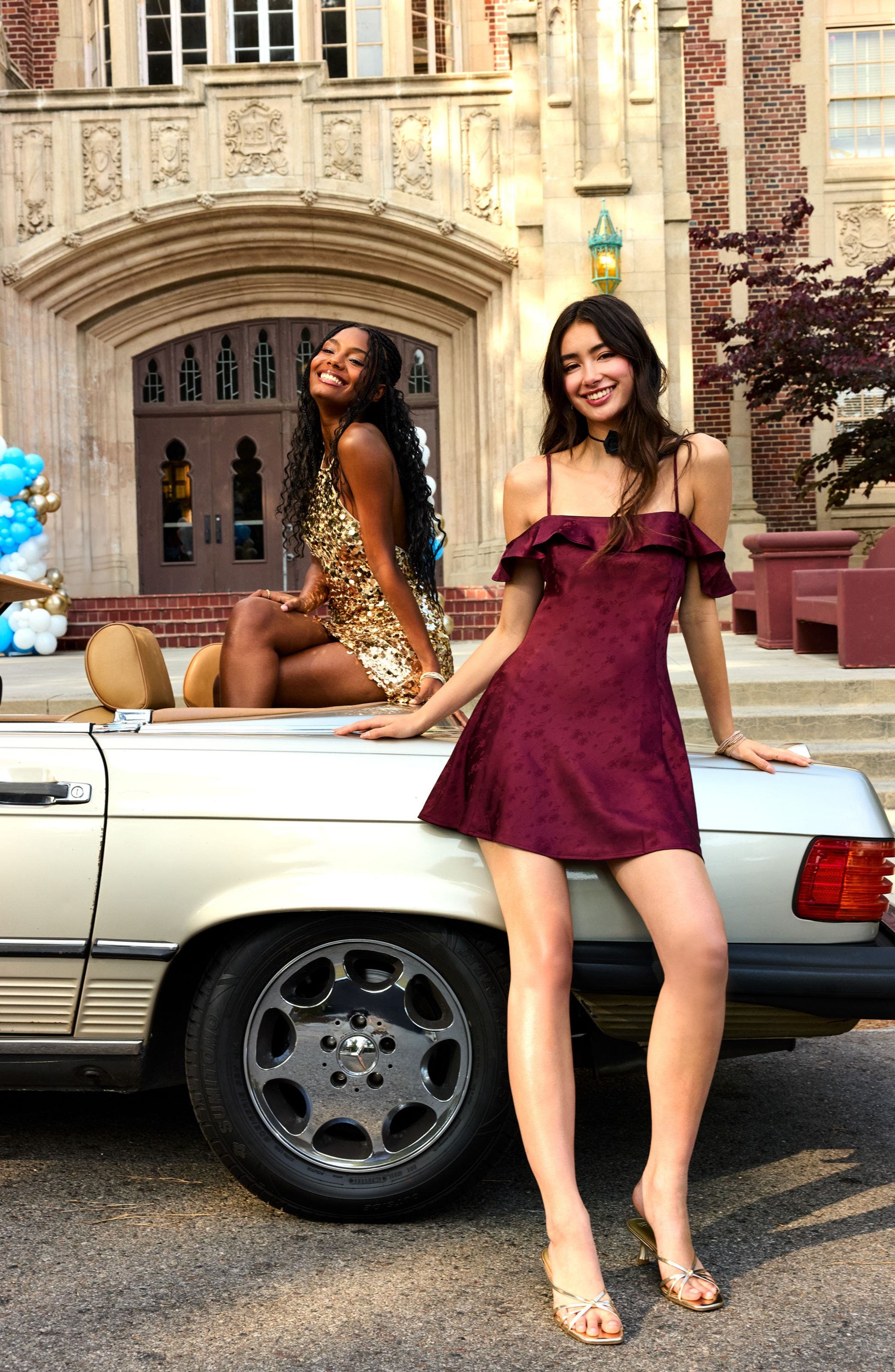 Two women wearing homecoming style mini dresses.