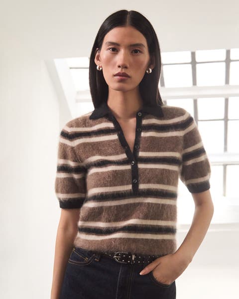 A woman wearing a striped top and jeans.
