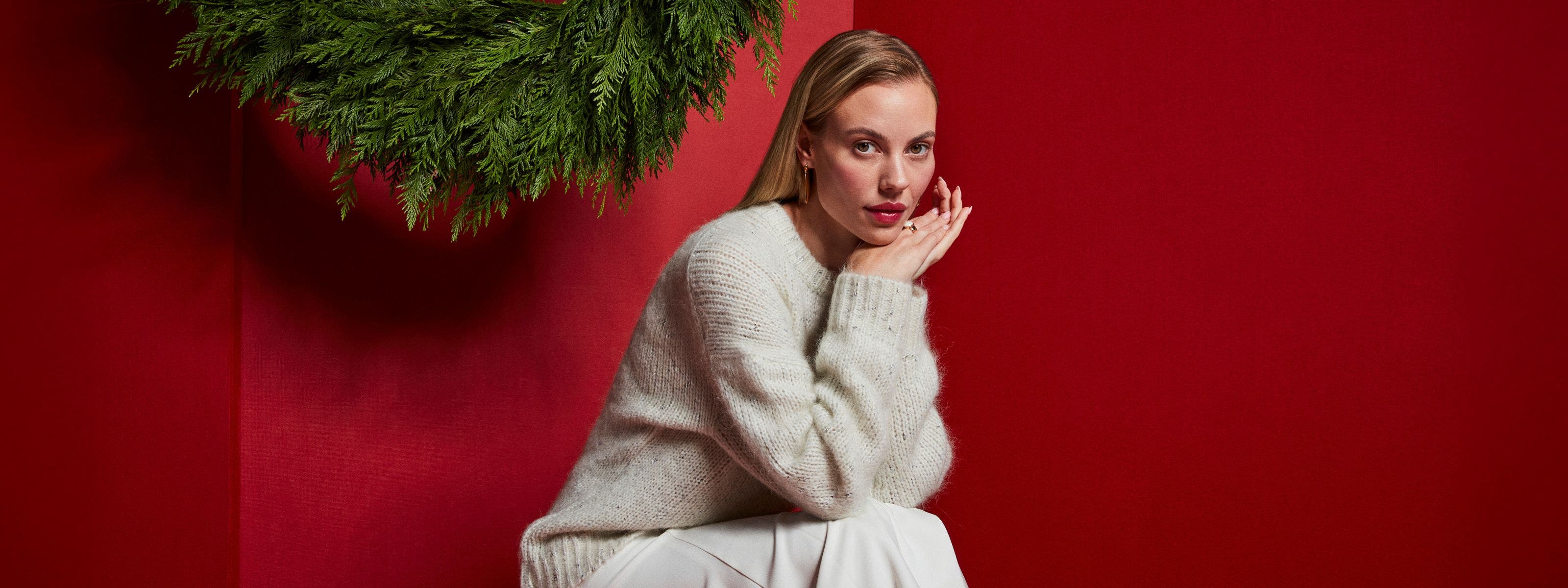 Woman wearing grey Nordstrom sweater.