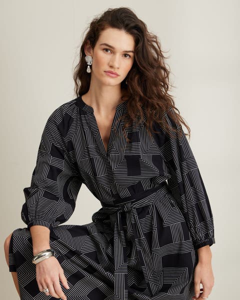 Woman wearing black patterned Nordstrom dress.