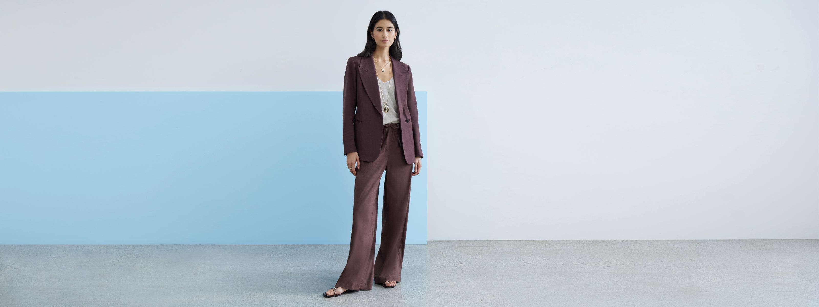 Woman wearing a purple matching suit pant and jacket. 