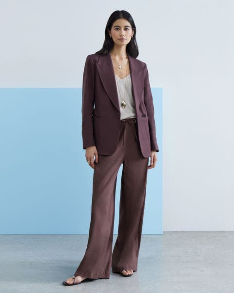 Woman wearing a purple matching suit pant and jacket.