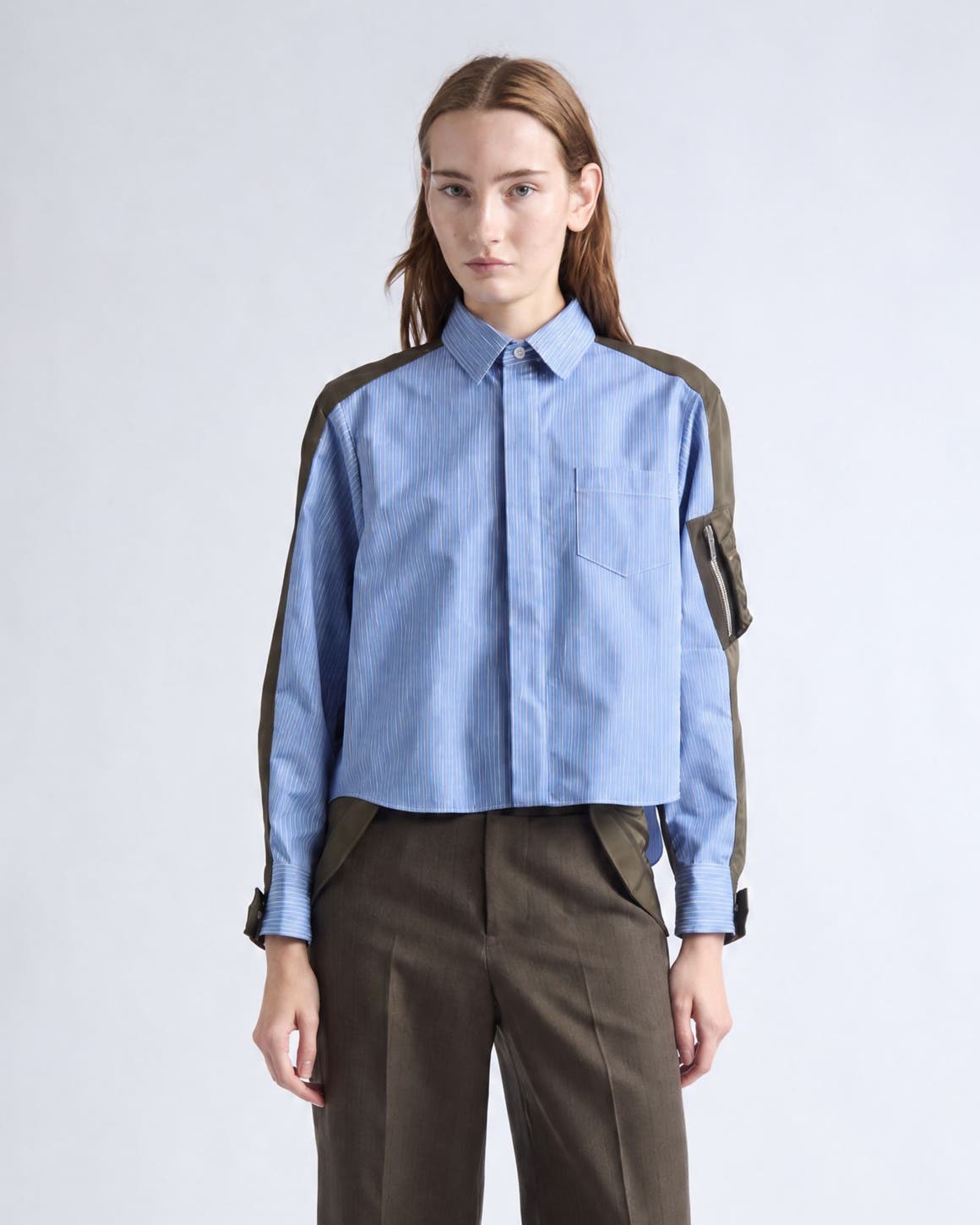 Women in SACAI blouse and trousers.