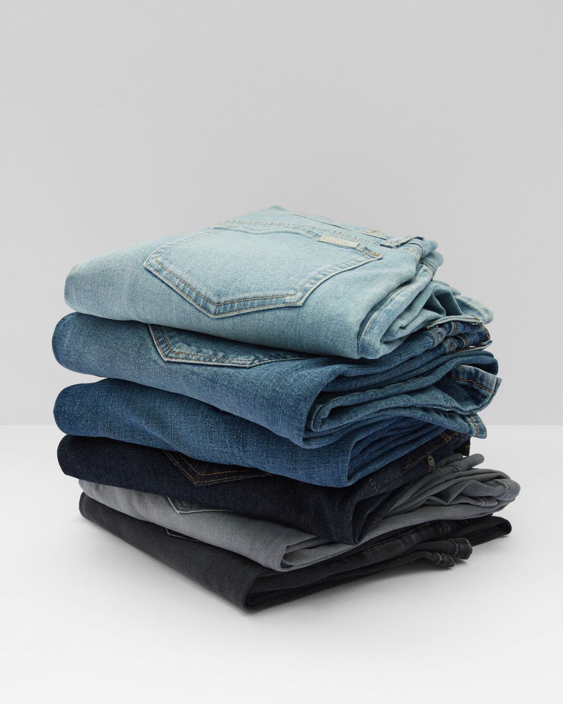 A stack of jeans in different washes. 