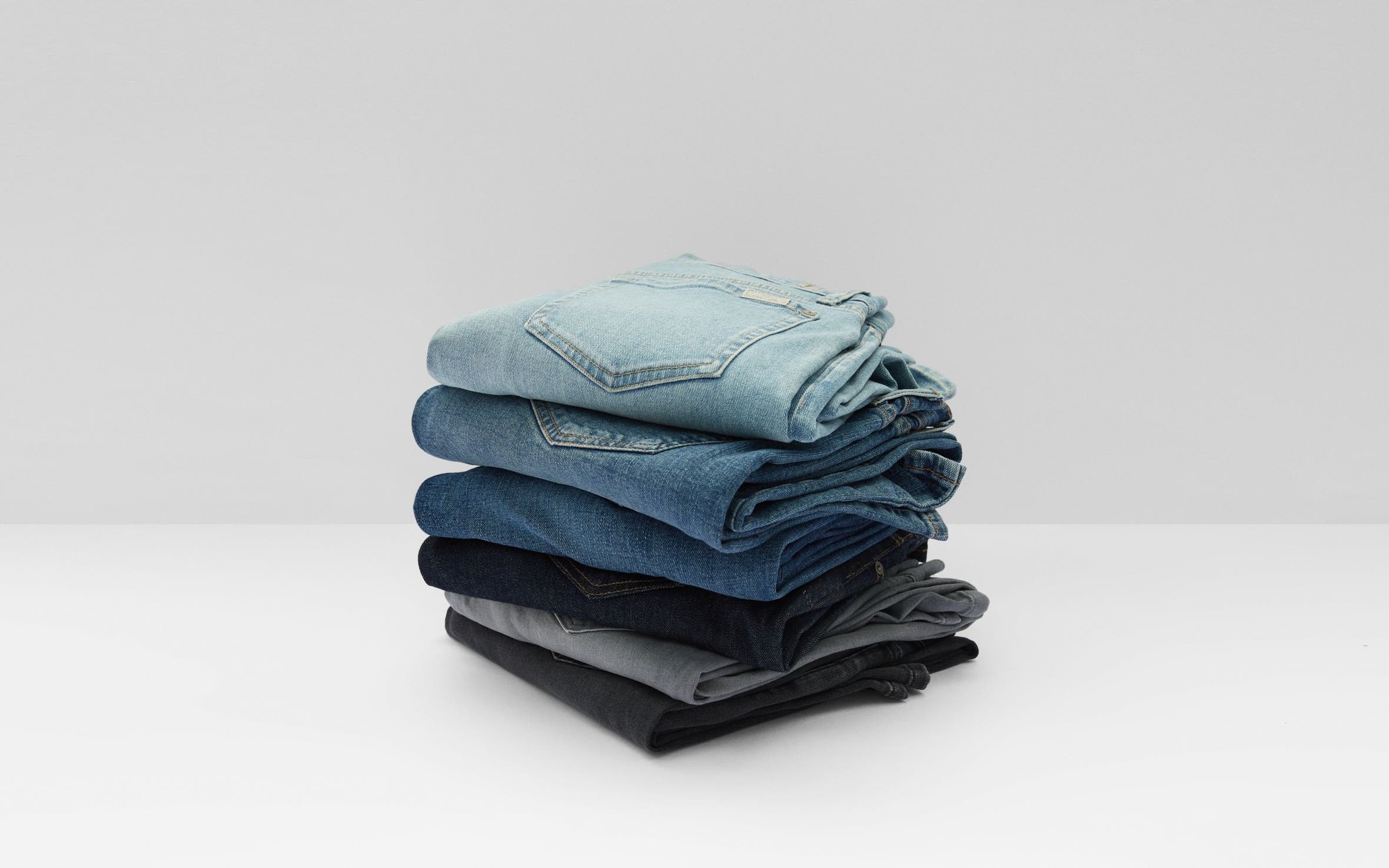 A stack of jeans in different washes. 