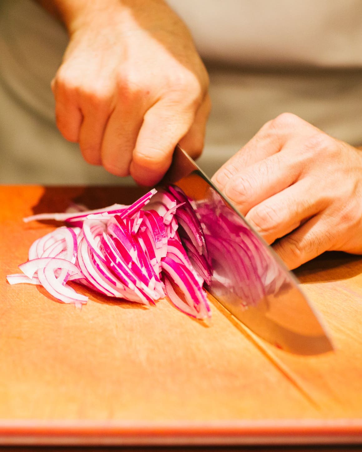 Bazille chef cutting onions.