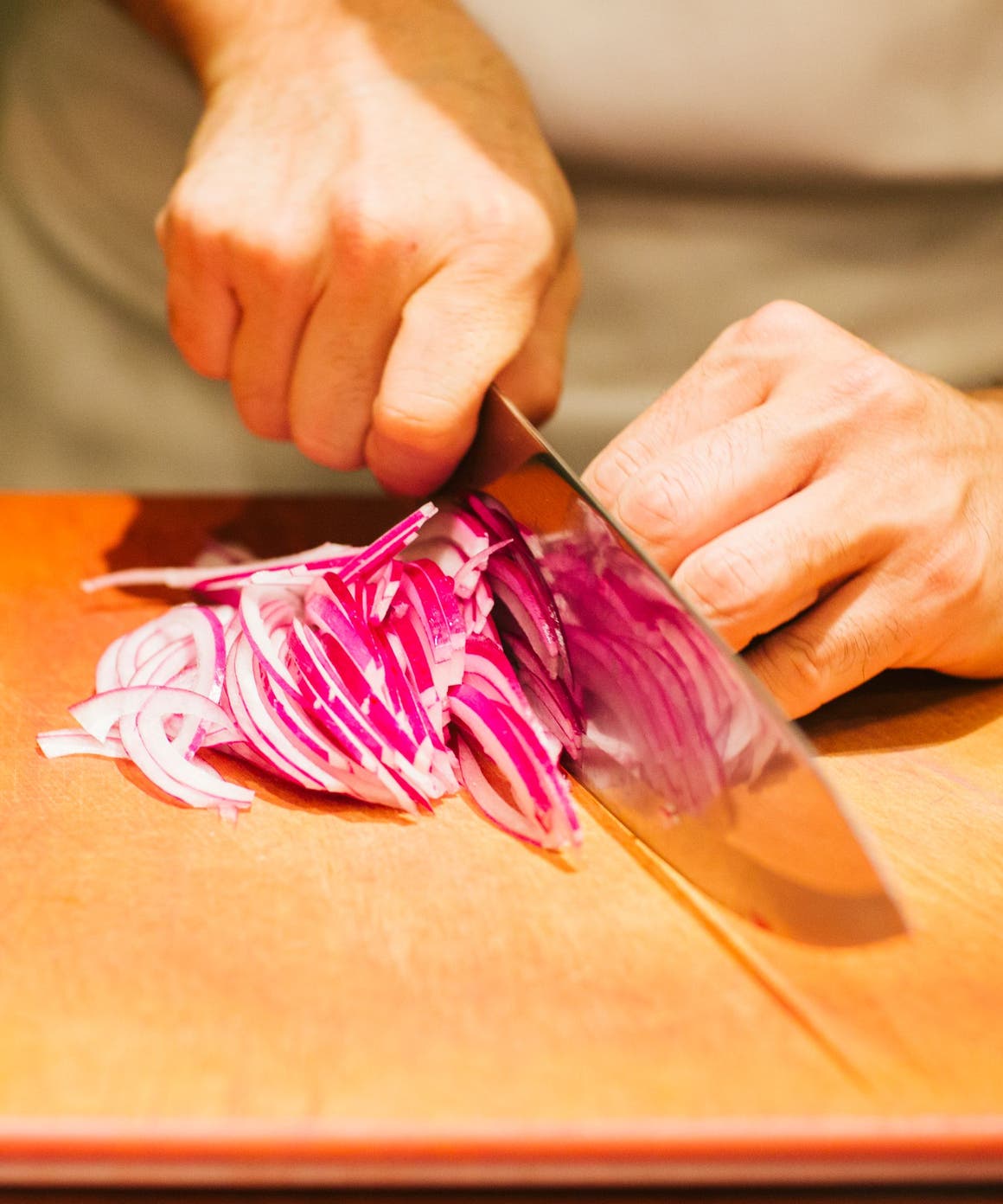 Bazille chef cutting onions.