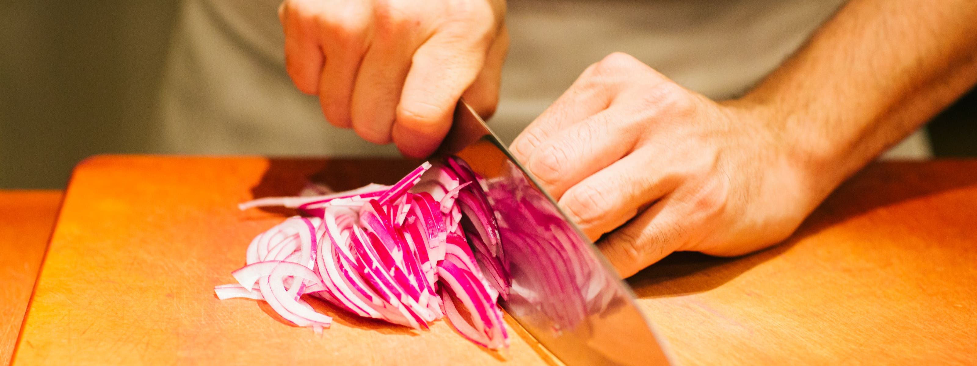 Bazille chef cutting onions.